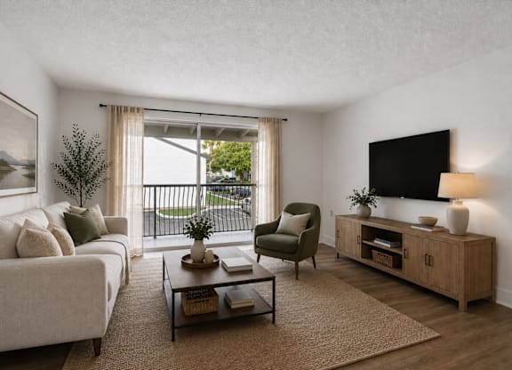 A living room with a couch, armchair, and television.