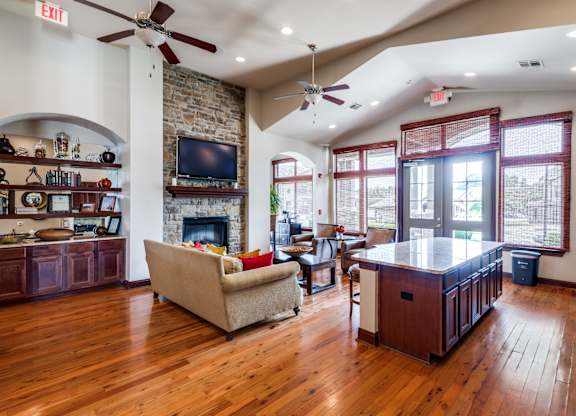 a living room with a fireplace and a kitchen