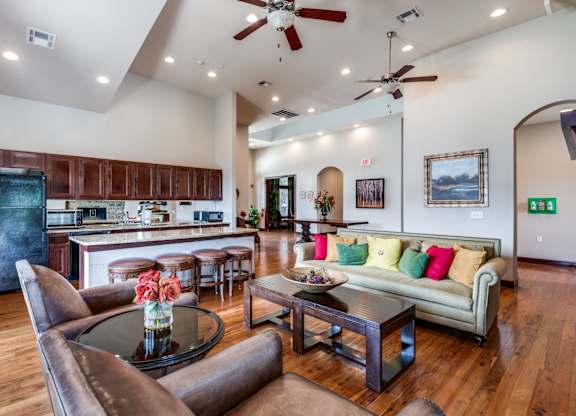a living room with a kitchen and a couch and a table