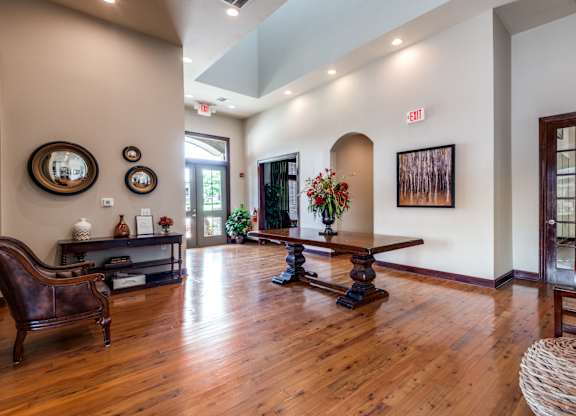 a living room with a hard wood floor and a table