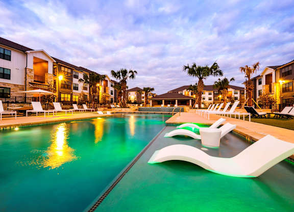 A swimming pool with a greenish tint and a white design on the side.
