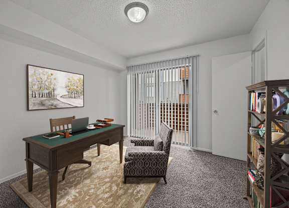 A room with a desk, chair, and bookshelf.
