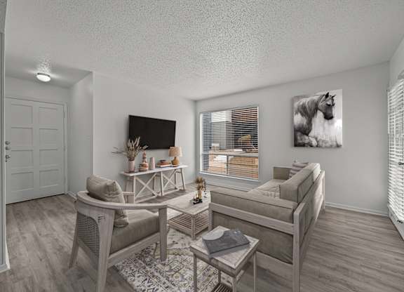 A living room with a couch, chair, and coffee table.