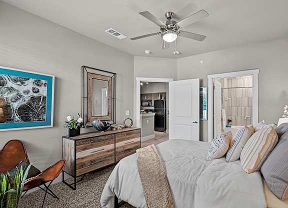 a bedroom with a large bed and a ceiling fan