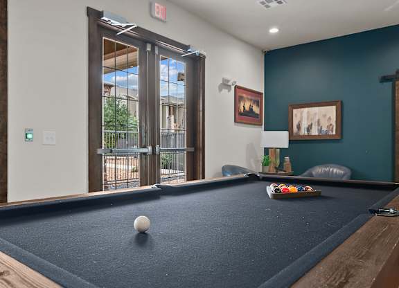 A pool table with a white ball on it.