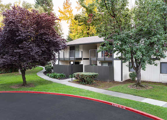 Apartment complex with a red line painted on the street.