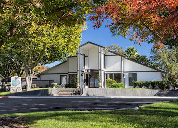 A modern house with a white exterior and a large front porch.