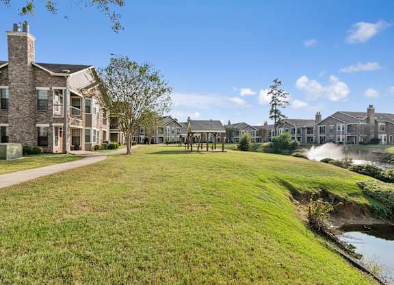 A row of houses with a grassy area in front.