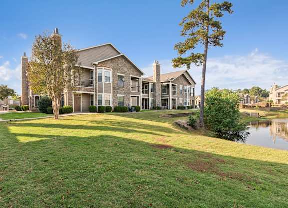 A large house with a green lawn in front.