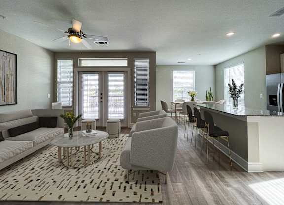 A modern living room with a white sofa, grey armchair, and a glass coffee table.