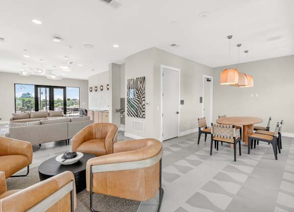 A living room with a grey floor and white walls.