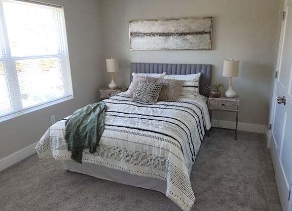 a bedroom with a bed and a window