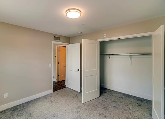 a bedroom with a closet and a door to a closet