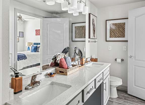 A bathroom with a white sink and a mirror.
