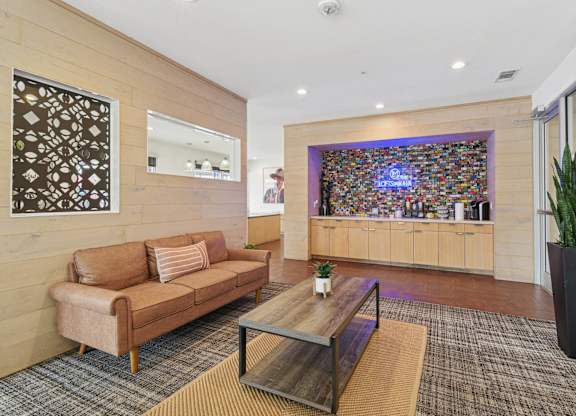 A living room with a brown couch and a coffee table.