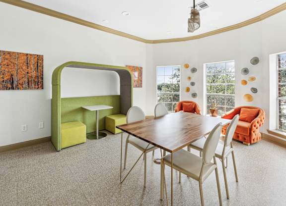 A dining room with a wooden table and chairs.