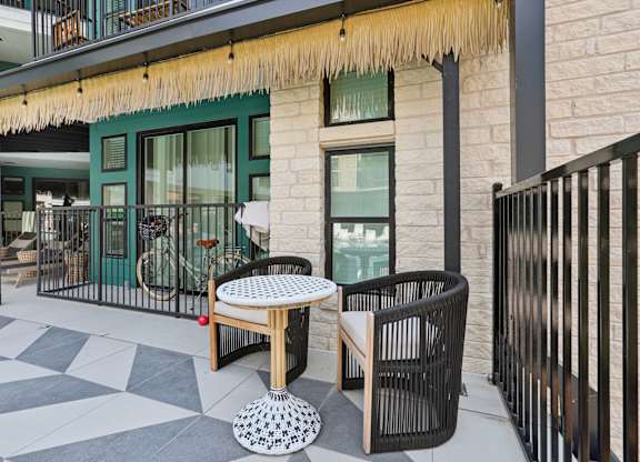 A patio with a table and chairs.