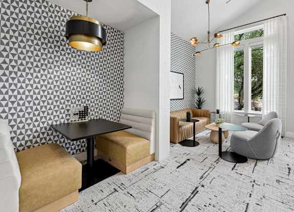 A modern dining area with a black table and chairs.