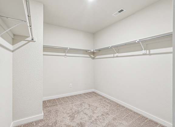 A white room with a carpeted floor and white walls.