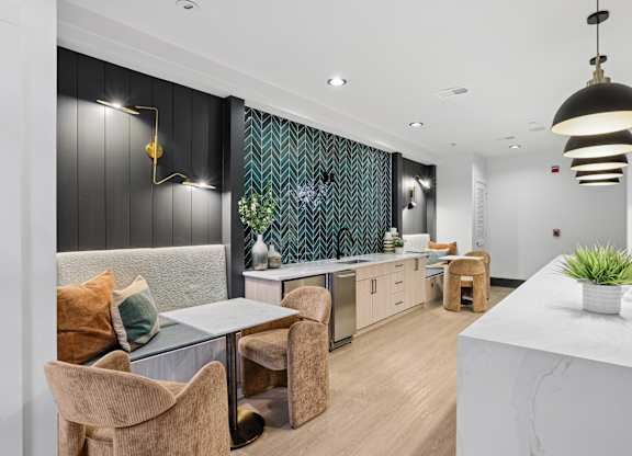 A modern kitchen with a dining table and chairs.