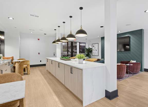 A modern kitchen with a white island and wooden cabinets.