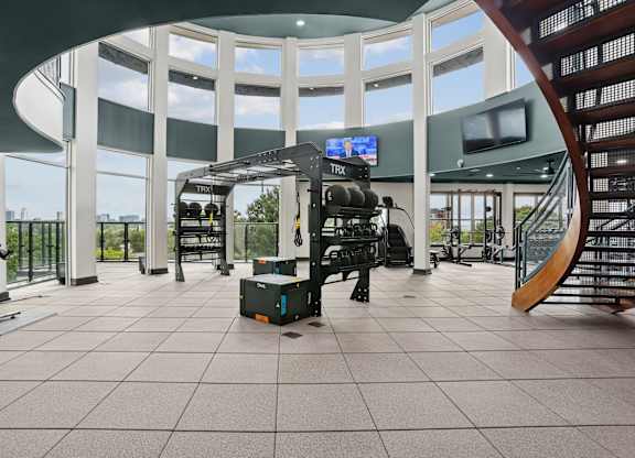 A gym with a treadmill, exercise bike, and other equipment.