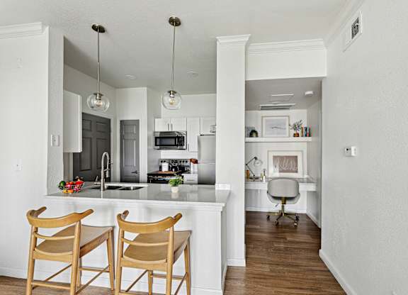 A kitchen with a bar area and a dining table.
