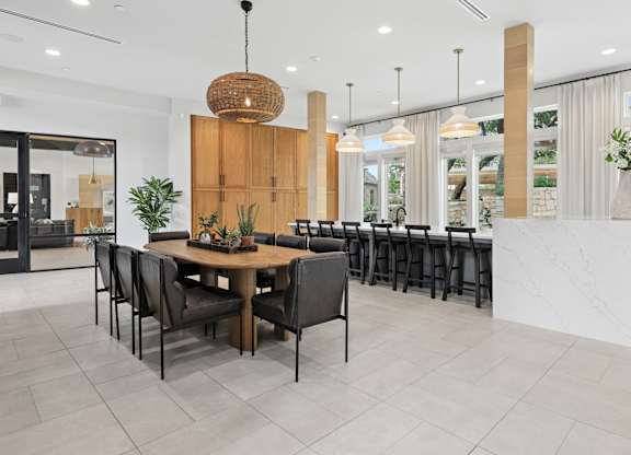 A modern dining area with a wooden table and chairs.