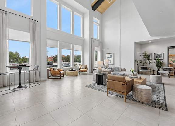 A modern living room with a glass table and chairs.