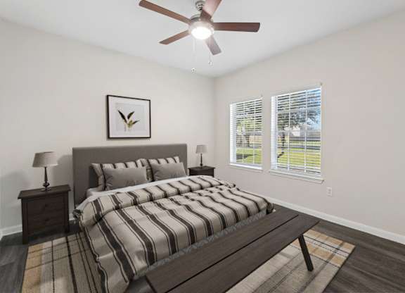 A bedroom with a bed, nightstand, and a ceiling fan.