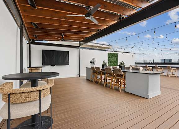 A wooden deck with a table and chairs.