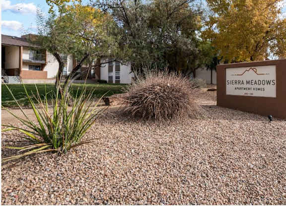 a sign for serene meadows in front of a building
