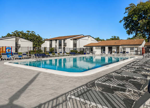 A large swimming pool surrounded by a black fence.
