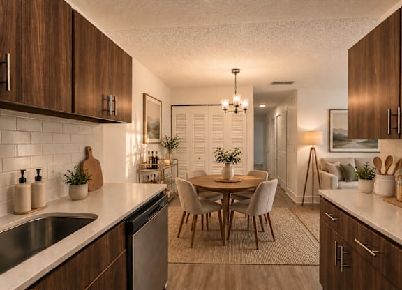 A kitchen with wooden cabinets and a dining table.