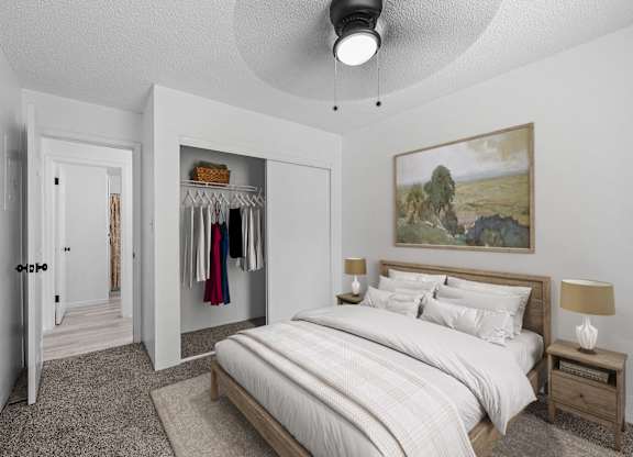 A bedroom with a large bed and a painting on the wall.