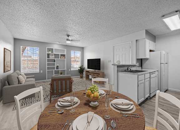 A dining room with a table set for a meal.