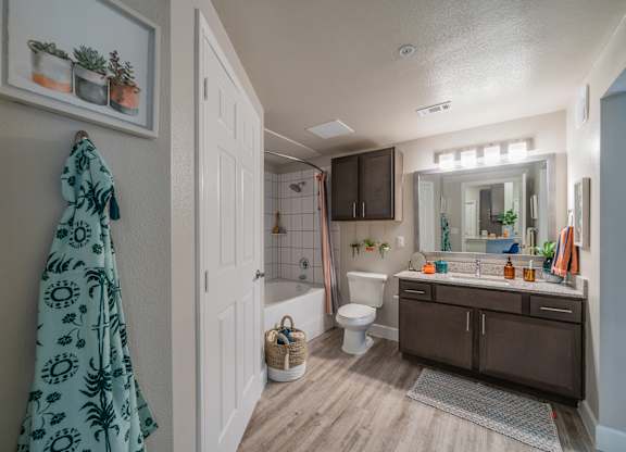 a bathroom with a white toilet next to a bathtub