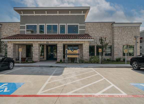 a building with a parking lot in front of it