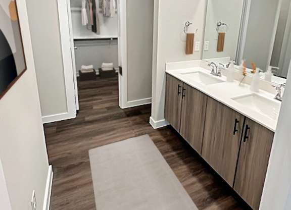 A bathroom with a white sink and a mirror.