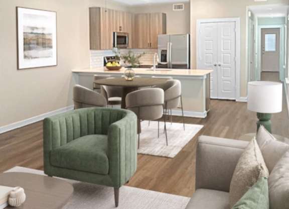 A living room with a green chair and a grey couch.