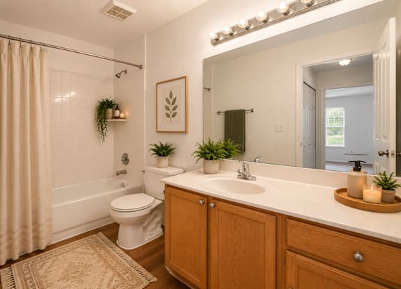 A bathroom with a white toilet, a white sink, and a white bathtub.