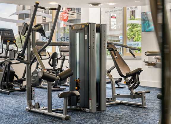 a row of exercise machines in a gym