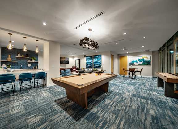 play a game of pool in our game room at our apartments