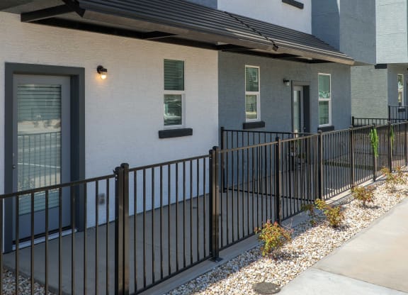 view of the front of a building with a black fence