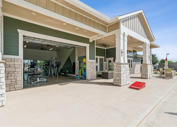 A building with a covered parking area in front.