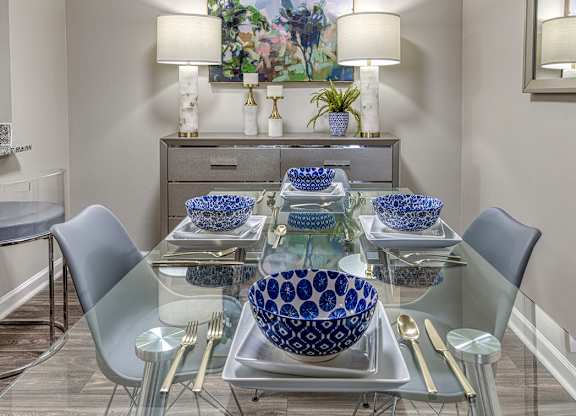 A dining table with blue and white bowls on it.