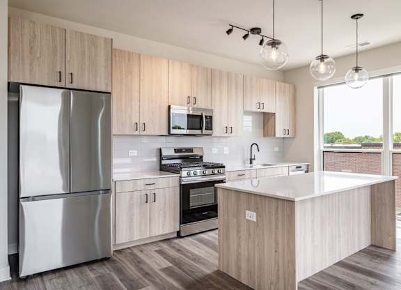 A modern kitchen with wooden cabinets and stainless steel appliances.
