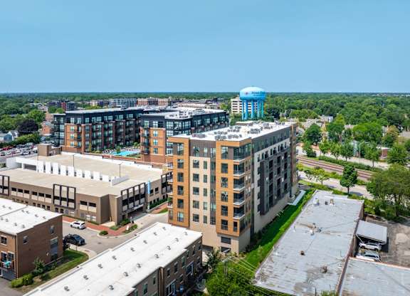 A large building complex with a blue water tower in the background.