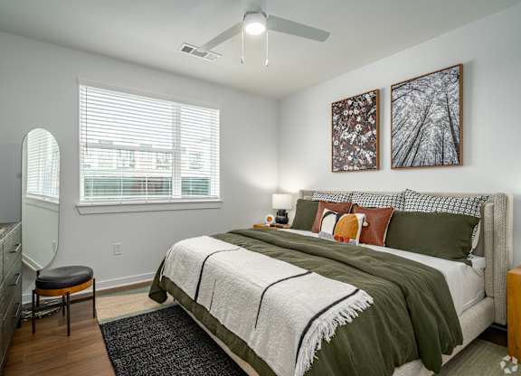 a bedroom with a bed and a ceiling fan