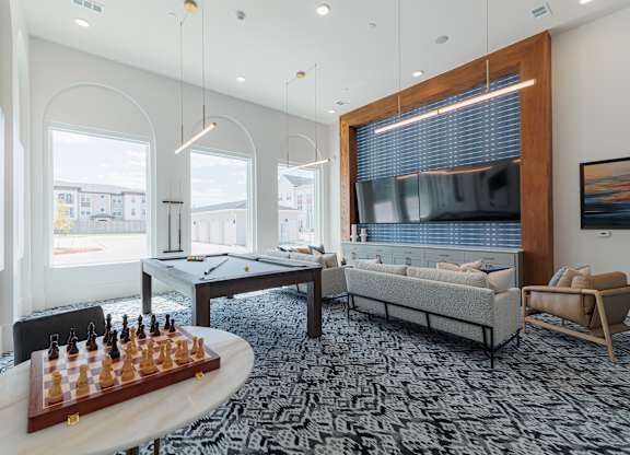 A living room with a chess board on the table.